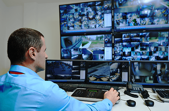 man monitoring CCTV security cameras
