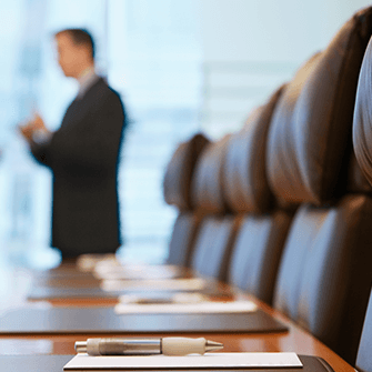 man wearing a suit standing in a meeting room