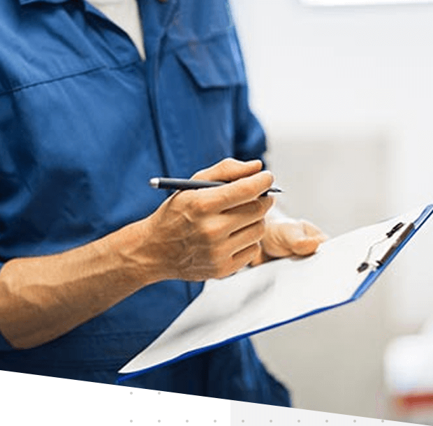 man wearing a blue shirt holding a pen and clipboard