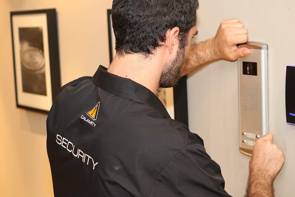 a Calamity employee installing a security alarm