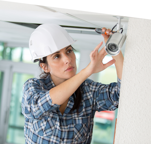 Female cctv installer installing security camera