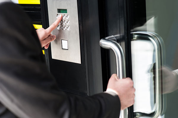 Man entering security code to unlock the door 